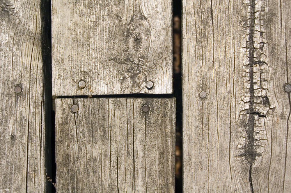 Weathered wooden planks of platform in park, close-up from above