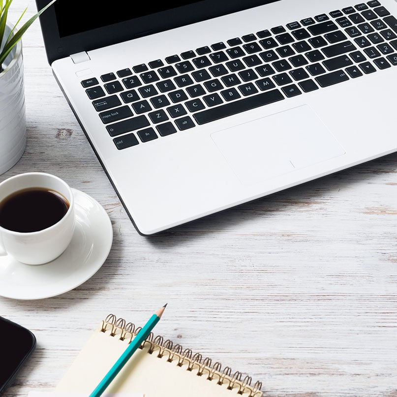computer-desk-with-notepad-and-coffee