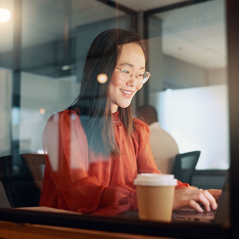 happy-woman-working-at-computer-desk